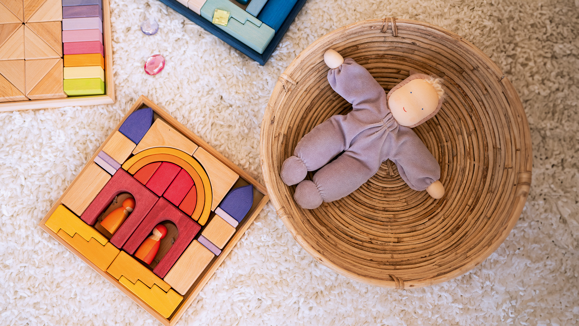 A building set and a doll lying on the floor