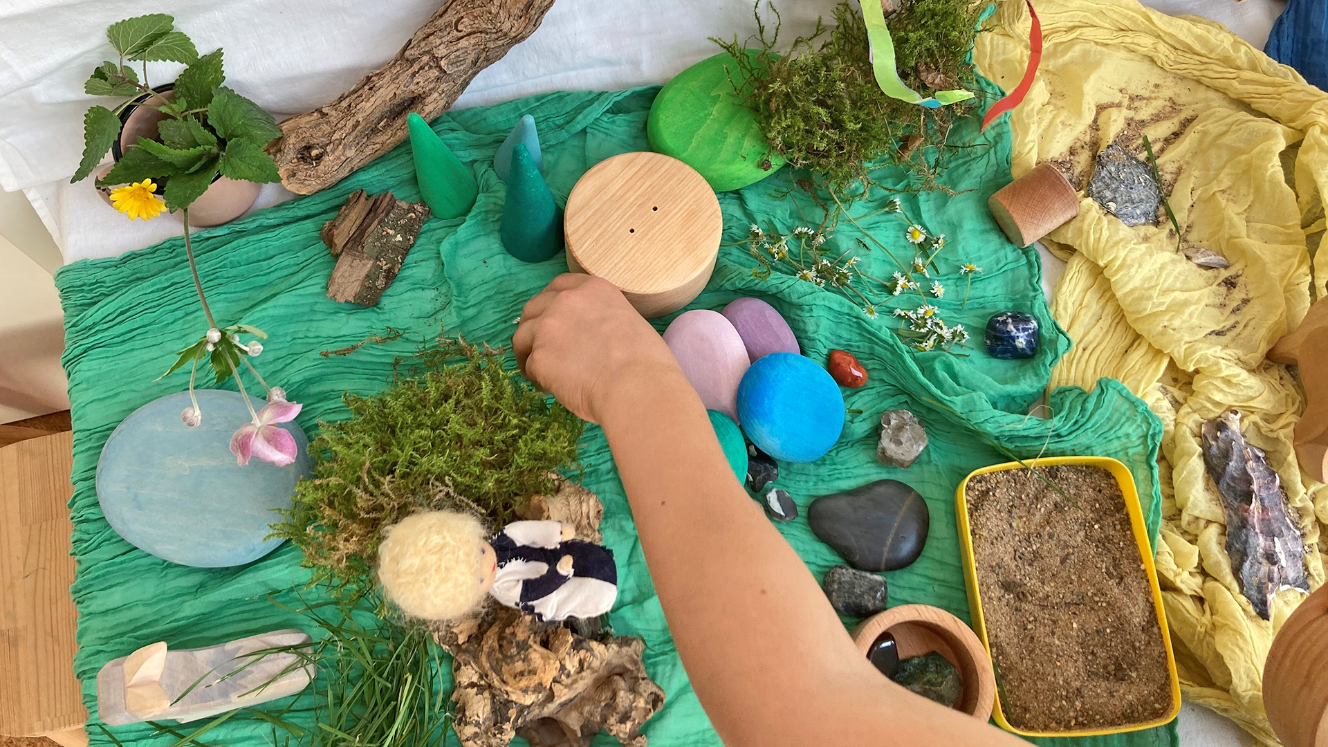 Colourfully decorated table with play materials and natural materials.